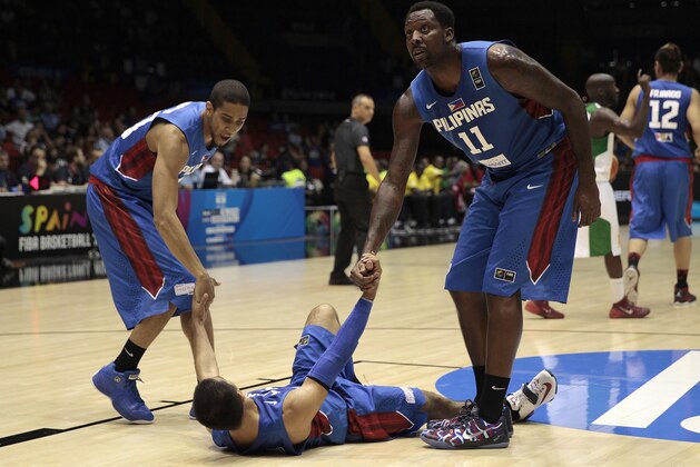 Philippines players Andray Blatche, right, and Gabe Norwood, left, help teammate Lewis Tenorio during the Group B Basketball World Cup match against Senegal in Seville, Spain, Thursday, Sept. 4, 2014. The 2014 Basketball World Cup competition will take place in various cities in Spain from Aug. 30 through to Sept. 14. (AP Photo/Miguel Angel Morenatti)