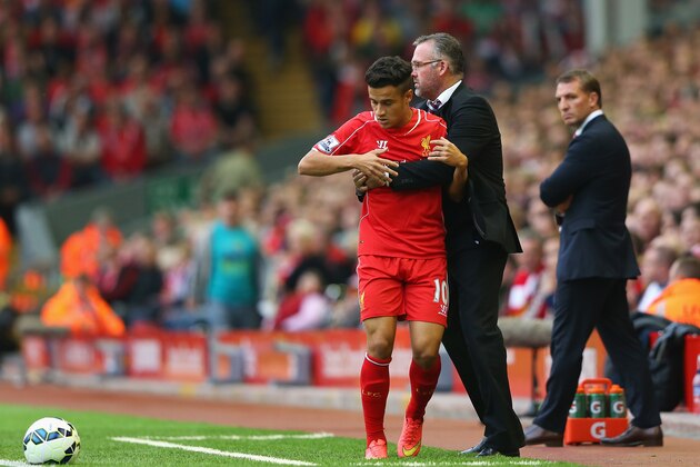 LIVERPOOL, ENGLAND - SEPTEMBER 13:  Philippe Coutinho of Liverpool collides with Paul Lambert, manager of Aston Villa after trying to keep the ball in play during the Barclays Premier League match between Liverpool and Aston Villa at Anfield on September 13, 2014 in Liverpool, England.  (Photo by Alex Livesey/Getty Images)