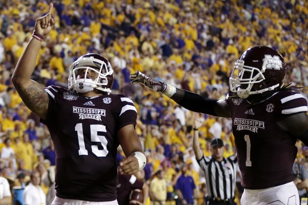 Mississippi State quarterback Dak Prescott (15) celebrates his 56 yard touchdown run with wide receiver De'Runnya Wilson (1) in the second half of an NCAA college football game against Mississippi State in Baton Rouge, La., Saturday, Sept. 20, 2014. (AP Photo/Gerald Herbert)