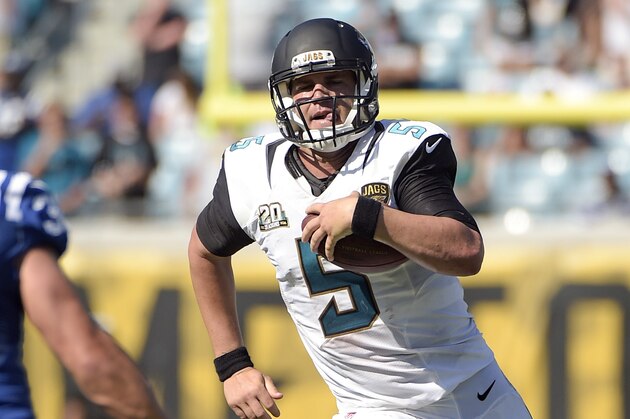 Jacksonville Jaguars quarterback Blake Bortles (5) scrambles for yardage as Indianapolis Colts free safety Colt Anderson (32) looks to stop him during the second half of an NFL football game in Jacksonville, Fla., Sunday, Sept. 21, 2014. Indianapolis won 44-17. (AP Photo/Phelan M. Ebenhack)
