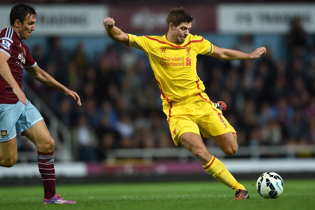 Liverpool’s Steven Gerrard, right, competes for the ball with West Ham United’s Stewart Downing during their English Premier League soccer match at Upton Park, London, Saturday, Sept. 20, 2014. (AP Photo/Tim Ireland)