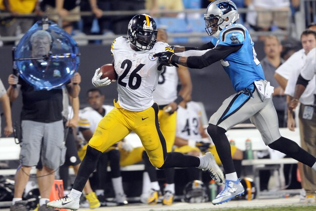 Pittsburgh Steelers' Le'Veon Bell (26) tries to break the tackle of Carolina Panthers' Thomas DeCoud (21) during the second half of an NFL football game in Charlotte, N.C., Sunday, Sept. 21, 2014. (AP Photo/Mike McCarn)