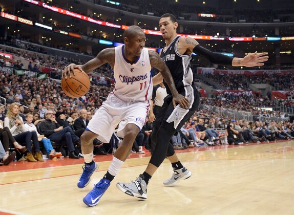 LOS ANGELES, CA - FEBRUARY 21:  Jamal Crawford #11 of the Los Angeles Clippers looks to dribble around Danny Green #4 of the San Antonio Spurs at Staples Center on February 21, 2013 in Los Angeles, California.  NOTE TO USER: User expressly acknowledges and agrees that, by downloading and or using this photograph, User is consenting to the terms and conditions of the Getty Images License Agreement.  (Photo by Harry How/Getty Images)