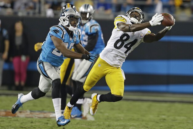 Pittsburgh Steelers' Antonio Brown (84) catches a pass as Carolina Panthers' Bene Benwikere (25) defends during the first half of an NFL football game in Charlotte, N.C., Sunday, Sept. 21, 2014. (AP Photo/Bob Leverone)
