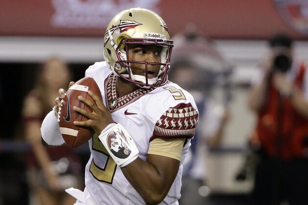 FILE - In this Aug. 30, 2014, file photo, Florida State quarterback Jameis Winston rolls out of the pocket in the first half of an NCAA college football game against Oklahoma State in Arlington, Texas. Florida State has suspended Winston for the entire game against Clemson on Saturday, Sept 20, extending its initial punishment of one half after the quarterback made