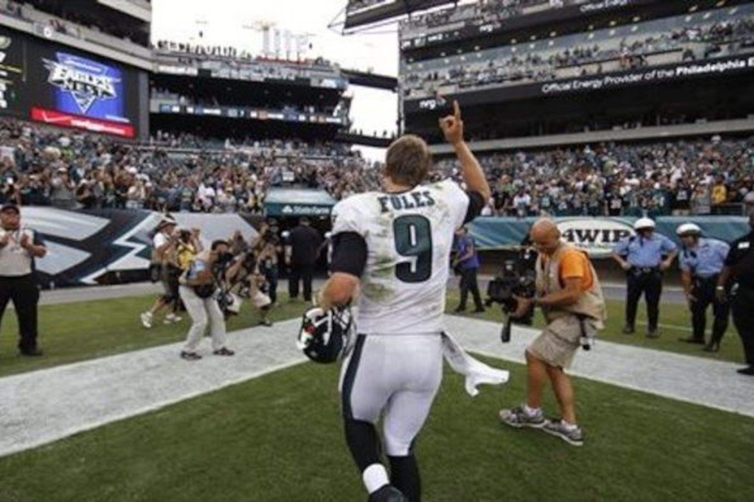 Philadelphia Eagles quarterback Nick Foles runs off the field after an NFL football game against the Washington Redskins, Sunday, Sept. 21, 2014, in Philadelphia. Philadelphia won 37-34. (AP Photo/Michael Perez)