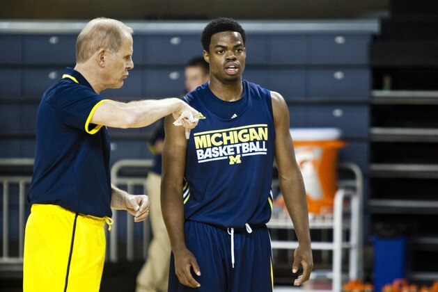 Michigan head coach John Beilein, left, gives direction to freshman guard Derrick Walton Jr. during a practice session after NCAA college basketball media day on Thursday, Oct. 24, 2013, in Ann Arbor, Mich. (AP Photo/Tony Ding)