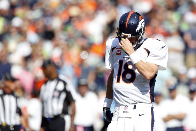Sep 21, 2014; Seattle, WA, USA; Denver Broncos quarterback Peyton Manning (18) walks back on to the field following a second quarter timeout against the Seattle Seahawks at CenturyLink Field. Mandatory Credit: Joe Nicholson-USA TODAY Sports