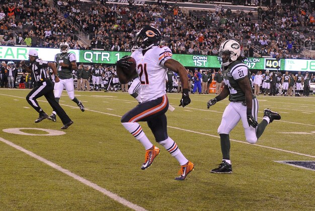 Sep 22, 2014; East Rutherford, NJ, USA; Chicago Bears strong safety Ryan Mundy (21) runs back an interception for a touchdown as New York Jets running back Chris Johnson (21) chases during the first quarter at MetLife Stadium. Mandatory Credit: Robert Deutsch-USA TODAY Sports