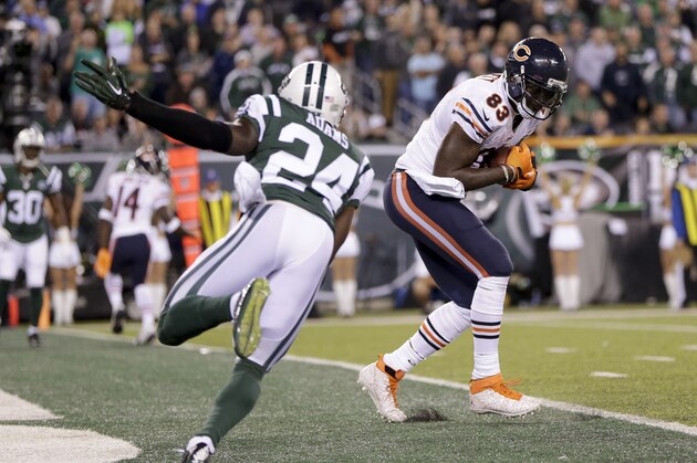 Chicago Bears tight end Martellus Bennett (83) comes down with a touchdown pass to score against New York Jets defensive back Phillip Adams (24) in the third quarter of an NFL football game, Monday, Sept. 22, 2014, in East Rutherford, N.J. (AP Photo/Julio Cortez)