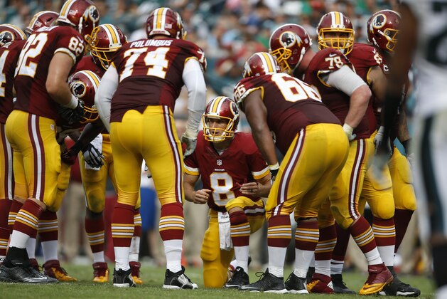 Washington Redskins quarterback Kirk Cousins (8) huddles with teammates during the second half of an NFL football game against the Washington Redskins, Sunday, Sept. 21, 2014, in Philadelphia. (AP Photo/Michael Perez)