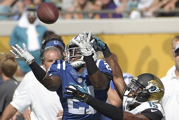Indianapolis Colts cornerback Vontae Davis (21) intercepts a pass intended for Jacksonville Jaguars wide receiver Allen Robinson (15) during the second half of an NFL football game in Jacksonville, Fla., Sunday, Sept. 21, 2014. (AP Photo/Phelan M. Ebenhack)