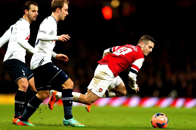 LONDON, ENGLAND - JANUARY 04:  Jack Wilshere of Arsenal is brought down by Christian Eriksen and Roberto Soldado of  Spurs during the Budweiser FA Cup third round match between Arsenal and Tottenham Hotspur at Emirates Stadium on January 4, 2014 in London, England.  (Photo by Clive Rose/Getty Images)