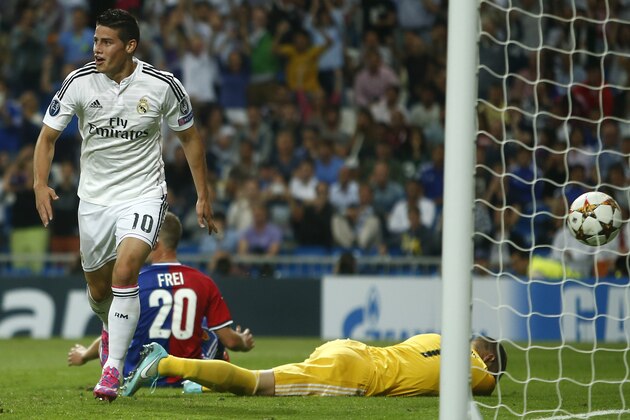 Real Madrid's James Rodriguez scores his side's fourth goal during the Champions League Group B soccer match between Real Madrid and Basel at the Santiago Bernabeu stadium in Madrid, Spain, Tuesday Sept. 16, 2014. (AP Photo/Andres Kudacki)