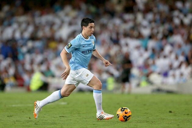AL AIN, UNITED ARAB EMIRATES - MAY 15:  Samir Nasri of Manchester City in action during the friendly match between Al Ain and Manchester City at Hazza bin Zayed Stadium on May 15, 2014 in Al Ain, United Arab Emirates.  (Photo by Warren Little/Getty Images)