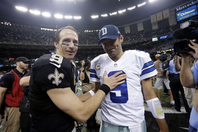 New Orleans Saints quarterback Drew Brees (9) greets Dallas Cowboys quarterback Tony Romo (9) after their NFL football game in New Orleans, Sunday, Nov. 10, 2013. The Saints won 49-17.  (AP Photo/Dave Martin)