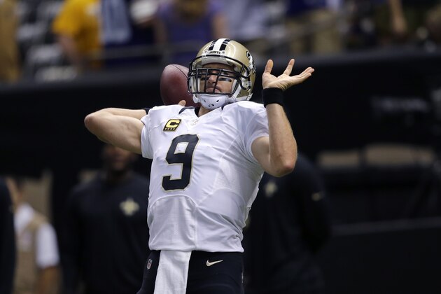 New Orleans Saints quarterback Drew Brees (9) warms up before an NFL football game against the Minnesota Vikings in New Orleans, Sunday, Sept. 21, 2014. (AP Photo/Bill Haber)