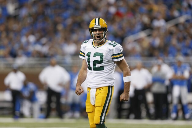Green Bay Packers quarterback Aaron Rodgers yells at teammates during the first half of an NFL football game against the Detroit Lions in Detroit, Sunday, Sept. 21, 2014. (AP Photo/Paul Sancya)