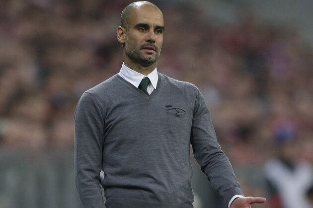 Bayern's head coach Pep Guardiola of Spain gestures during the Champions League Group E soccer match between FC Bayern Munich and Manchester City at Allianz Arena in Munich, southern Germany, Wednesday Sept. 17, 2014. (AP Photo/Matthias Schrader)