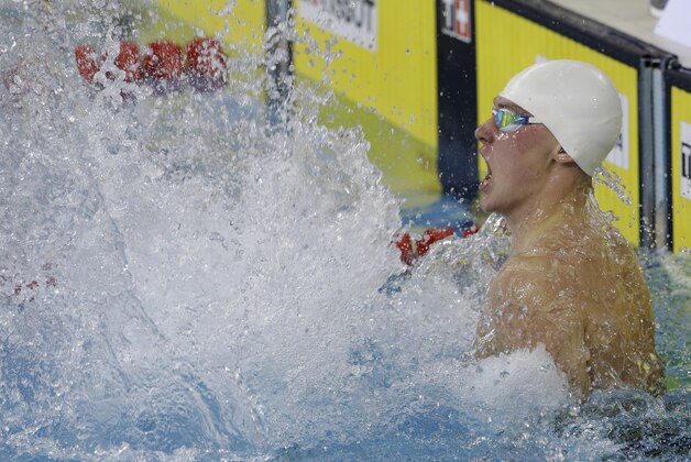 Kazakhstan's Dmitriy Balandin celebrates after winning the men's 200-meter breaststroke swimming final at the 17th Asian Games in Incheon, South Korea, Tuesday, Sept. 23, 2014.  (AP Photo/Lee Jin-man)