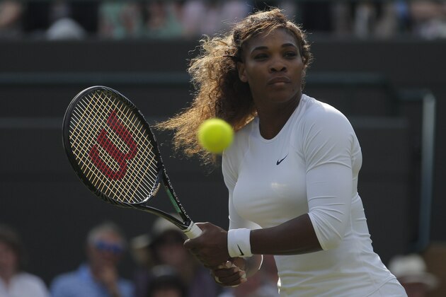 Serena Williams goes to play a return with partner Venus Williams of the U.S in their women's doubles match against Kristina Barrios of Germany and Stefanie Voegele of Switzerland at the All England Lawn Tennis Championships in Wimbledon, London, Tuesday July 1, 2014. The Williams sisters retired after 3 games. (AP Photo/Pavel Golovkin)