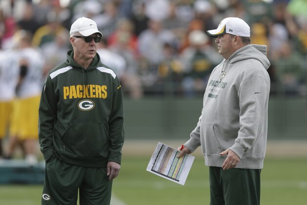 Green Bay Packers head coach Mike McCarthy talks to general manager Ted Thompson, left, during NFL football training camp Saturday, July 27, 2013, in Green Bay, Wis. (AP Photo/Morry Gash)