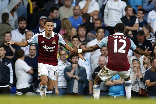 West Ham United's Ravel Morrison, left, celebrates after scoring against Tottenham Hotspur with his teammate Ricardo Vaz Te, right, during an English Premier League soccer match at the White Hart Lane ground in London, Sunday, Oct. 6, 2013. West Ham United won the game 3-0. (AP Photo/Lefteris Pitarakis)