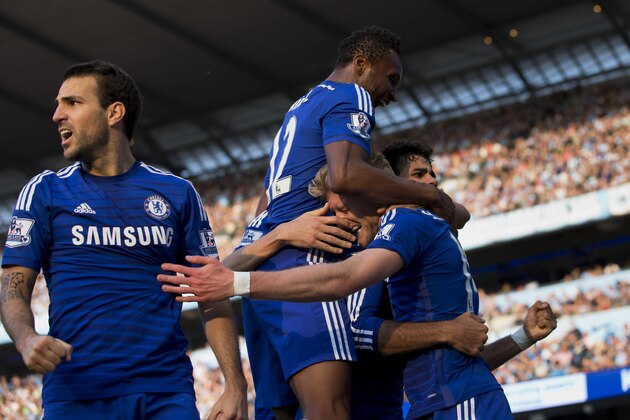 Chelsea's Andre Schuerrle, bottom right, celebrates with teammates after scoring against Manchester City during their English Premier League soccer match at the Etihad Stadium, Manchester, England, Sunday Sept. 21, 2014. (AP Photo/Jon Super)