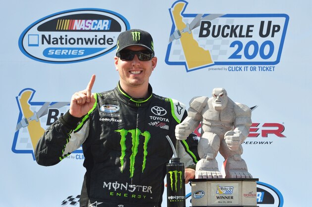 DOVER, DE - MAY 31:  Kyle Busch, driver of the #54 Monster Energy Toyota, poses with the Miles The Monster trophy after winning the NASCAR Nationwide Series Buckle Up 200 Presented By Click It Or Ticket at Dover International Speedway on May 31, 2014 in Dover, Delaware.  (Photo by Drew Hallowell/Getty Images)