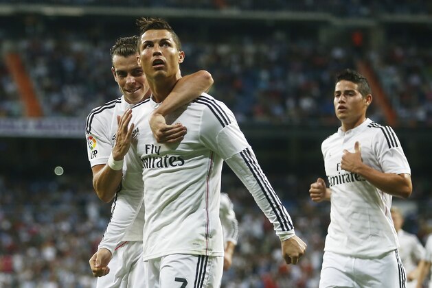 Real's Cristiano Ronaldo, second left, celebrates his goal with Real's Gareth Bale, left, during a Spanish La Liga soccer match between Real Madrid and Elche at the Santiago Bernabeu stadium in Madrid, Spain, Tuesday, Sept. 23, 2014. (AP Photo/Andres Kudacki)