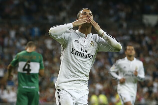 Real's Cristiano Ronaldo celebrates his third goal during a Spanish La Liga soccer match between Real Madrid and Elche at the Santiago Bernabeu stadium in Madrid, Spain, Tuesday, Sept. 23, 2014. (AP Photo/Andres Kudacki)