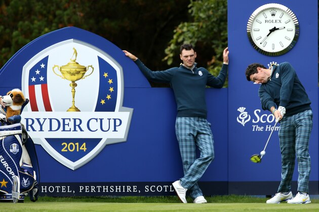 Europe’s Rory McIlroy plays a shot off the 15th tee as Martin Kaymer looks on during a practice round ahead of the Ryder Cup golf tournament at Gleneagles, Scotland, Tuesday, Sept. 23, 2014. (AP Photo/Peter Morrison)