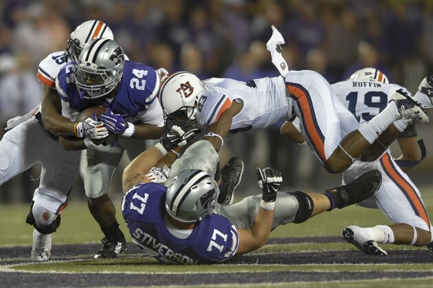 Kansas State Wildcats running back Charles Jones (24) is tackled by Auburn Tigers defensive back Johnathan Ford (23) and Auburn Tigers defensive back Joshua Holsey (15) during an NCAA college football game Thursday, Sept. 18, 2014 in Manhattan, Kan. (AP Photo/Reed Hoffmann) Kansas State Wildcats running back Charles Jones (24) is tackled by Auburn Tigers defensive back Johnathan Ford (23) and Auburn Tigers defensive back Joshua Holsey (15) during an NCAA college football game Thursday, Sept. 18, 2014 in Manhattan, Kan. (AP Photo/Reed Hoffmann)