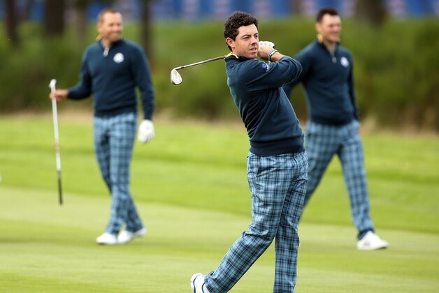 Europe’s Rory McIlroy plays a shot on the 15th fairway as Sergio Garcia, left, and Martin Kaymer look along the fairway during a practice round ahead of the Ryder Cup golf tournament at Gleneagles, Scotland, Tuesday, Sept. 23, 2014. (AP Photo/Peter Morrison)