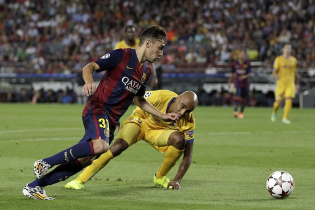 Barcelona's Munir El Haddadi, left, goes for the ball as APOEL's Da Cruz Junior tries to stop him during the Champions League Group F soccer match between Barcelona and Apoel at the Camp Nou stadium in Barcelona, Spain, Wednesday, Sept. 17, 2014. (AP Photo/Emilio Morenatti)