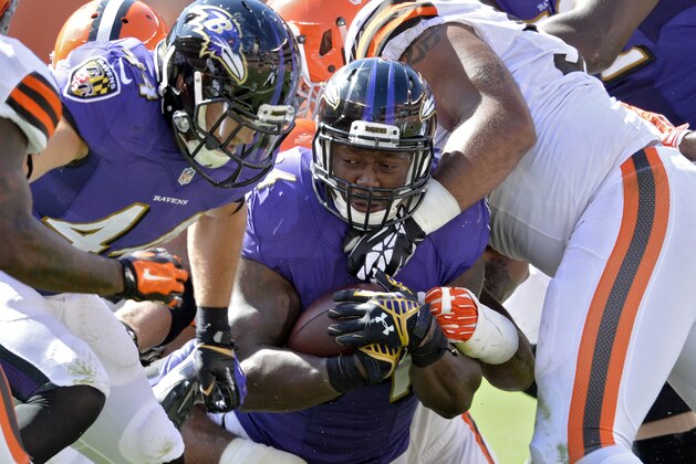 Baltimore Ravens running back Lorenzo Taliaferro is stopped by the Cleveland Browns defense in the third quarter of an NFL football game Sunday, Sept. 21, 2014, in Cleveland. (AP Photo/David Richard)