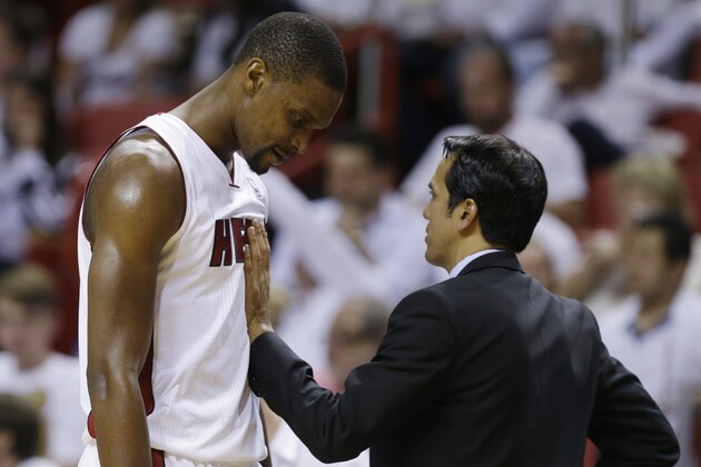 Miami Heat head coach Erik Spoelstra restrains center Chris Bosh (1) during the second half of Game 3 in the NBA basketball Eastern Conference finals playoff series against the Indiana Pacers, Saturday, May 24, 2014, in Miami. (AP Photo/Lynne Sladky)