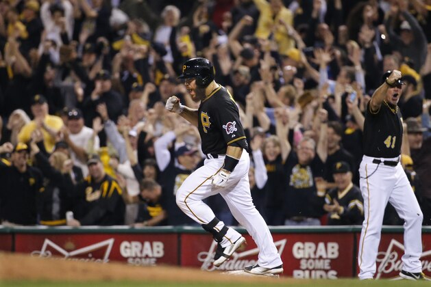 Pittsburgh Pirates' Russell Martin (55) rounds first base after hitting a three-run home run off Milwaukee Brewers relief pitcher Jonathan Broxton during the eighth inning of a baseball game in Pittsburgh Friday, Sept. 19, 2014. The Pirates won 4-2. (AP Photo/Gene Puskar)