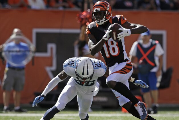 Cincinnati Bengals wide receiver A.J. Green (18) is tackled by Tennessee Titans cornerback Blidi Wreh-Wilson (25) in the second half of an NFL football game, Sunday, Sept. 21, 2014, in Cincinnati. (AP Photo/Darron Cummings)