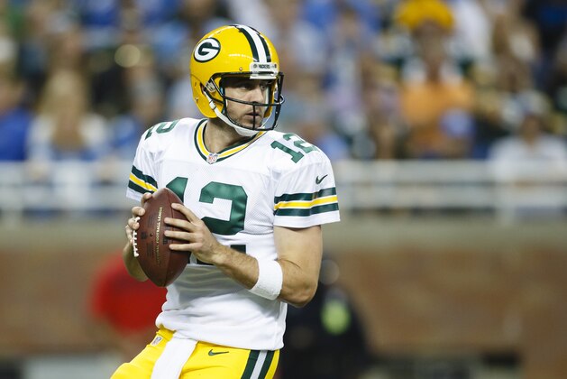 Green Bay Packers quarterback Aaron Rodgers (12) drops back to pass against the Detroit Lions during an NFL football game at Ford Field in Detroit, Sunday, Sept. 21, 2014. (AP Photo/Rick Osentoski)