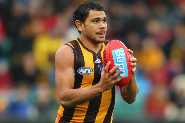 LAUNCESTON, AUSTRALIA - JUNE 28:  Cyril Rioli of the Hawks runs with the ball during the round 15 AFL match between the Hawthorn Hawks and the Gold Coast Suns at Aurora Stadium on June 28, 2014 in Launceston, Australia.  (Photo by Scott Barbour/Getty Images)