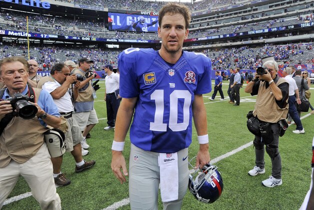 New York Giants quarterback Eli Manning (10) walks off the field after the Giants beat the Houston Texans 30-17 in an NFL football game, Sunday, Sept. 21, 2014, in East Rutherford, N.J. (AP Photo/Bill Kostroun)