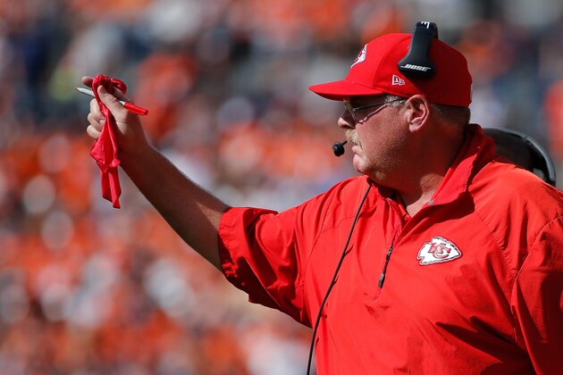 DENVER, CO - SEPTEMBER 14:  Head coach Andy Reid of the Kansas City Chiefs pulls out a red challenge flag on an incomplete pass call that was overturned in the second quarter of a game between the Denver Broncos and the Kansas City Chiefs at Sports Authority Field at Mile High on September 14, 2014 in Denver, Colorado.  (Photo by Doug Pensinger/Getty Images)
