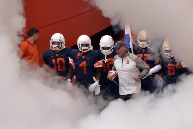 Sep 20, 2014; Syracuse, NY, USA; Syracuse Orange head coach Scott Shafer leads his team onto the field prior to a game against the Maryland Terrapins   at the Carrier Dome. Maryland won the game 34-20. Mandatory Credit: Mark Konezny-USA TODAY Sports