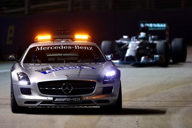 SINGAPORE - SEPTEMBER 21:  The Safety Car drives ahead of Lewis Hamilton of Great Britain and Mercedes GP during the Singapore Formula One Grand Prix at Marina Bay Street Circuit on September 21, 2014 in Singapore, Singapore.  (Photo by Mark Thompson/Getty Images)