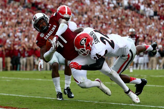 COLUMBIA, SC - SEPTEMBER 13:  Teammates Damian Swann #5 and Dominick Sanders #24 of the Georgia Bulldogs watch as Pharoh Cooper #11 of the South Carolina Gamecocks scores a touchdown during their game at Williams-Brice Stadium on September 13, 2014 in Columbia, South Carolina.  (Photo by Streeter Lecka/Getty Images)