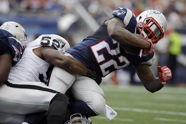Oakland Raiders outside linebacker Khalil Mack (52) tackles New England Patriots running back Stevan Ridley (22) in the first half of an NFL football game Sunday, Sept. 21, 2014, in Foxborough, Mass. (AP Photo/Steven Senne) Oakland Raiders outside linebacker Khalil Mack (52) tackles New England Patriots running back Stevan Ridley (22) in the first half of an NFL football game Sunday, Sept. 21, 2014, in Foxborough, Mass. (AP Photo/Steven Senne)
