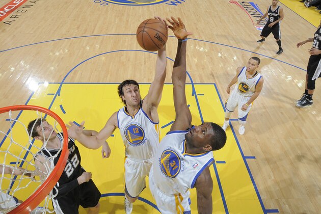 OAKLAND, CA - MAY 16: Andrew Bogut #12 and Festus Ezeli #31 reach for a rebound against the San Antonio Spurs in Game Six of the Western Conference Semifinals during the 2013 NBA Playoffs on May 16, 2013 at Oracle Arena in Oakland, California. NOTE TO USER: User expressly acknowledges and agrees that, by downloading and or using this photograph, user is consenting to the terms and conditions of Getty Images License Agreement. Mandatory Copyright Notice: Copyright 2013 NBAE (Photo by Rocky Widner/NBAE via Getty Images)