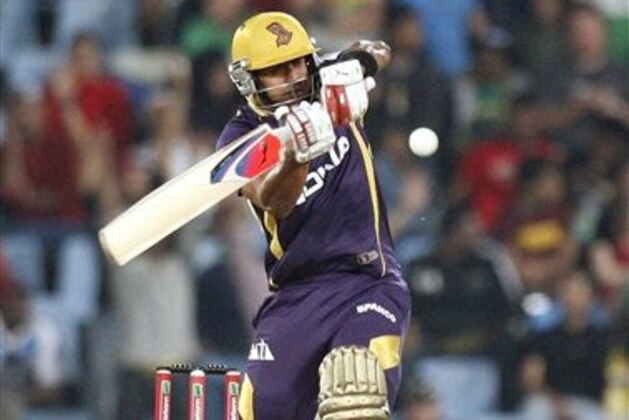 Kolkata Knight Riders's batsman Manoj Tiwary plays a shot from Delhi Daredevils's bowler Umesh Yadav, unseen, during the  Champions League Twenty20 cricket match at the Centurion Park in Pretoria, South Africa, Saturday, Oct. 13, 2012. (AP Photo/ Themba Hadebe)