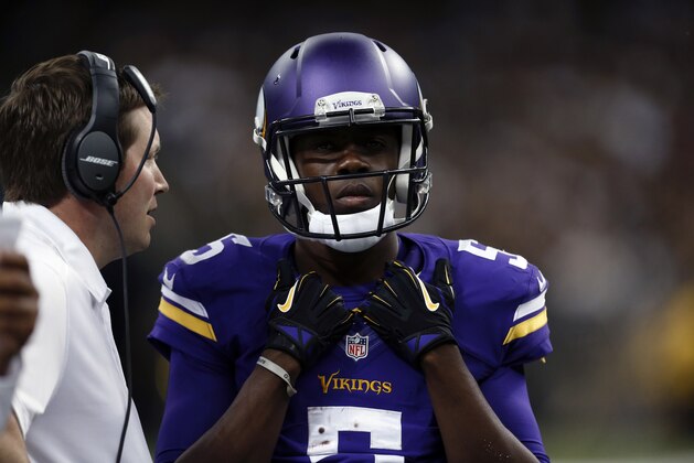 Minnesota Vikings quarterback Teddy Bridgewater (5) talks with quarterbacks coach Scott Turner in the second half of an NFL football game against the New Orleans Saints in New Orleans, Sunday, Sept. 21, 2014. (AP Photo/Rogelio Solis)